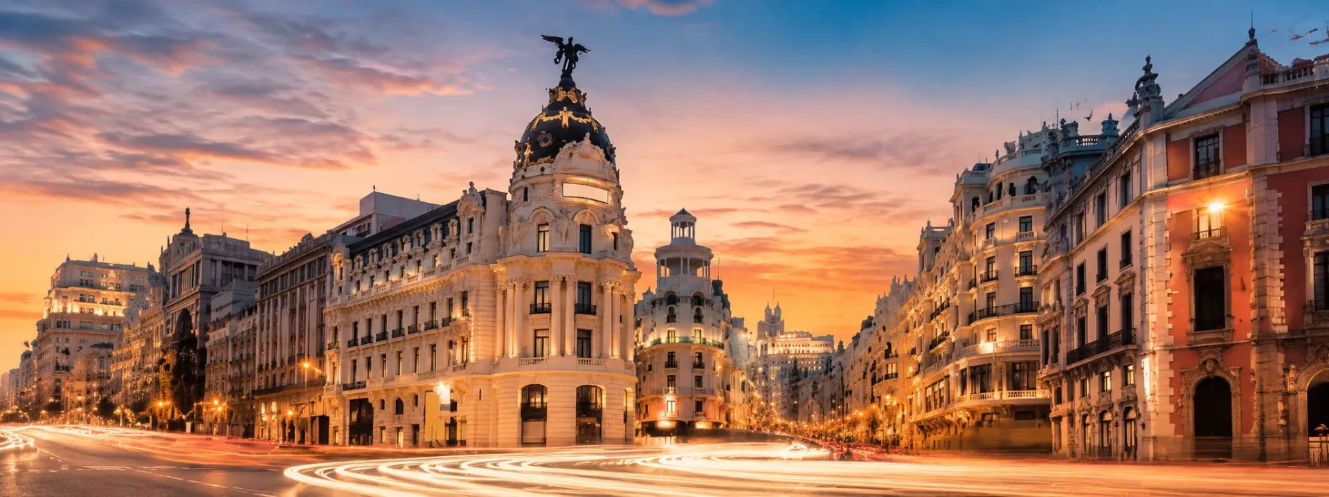 Madrid at golden hour — Metropolis Building and light trails
